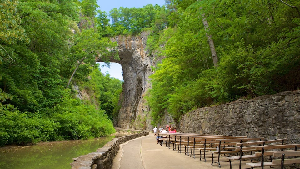 A stone bench area with a view of a natural rock formation.