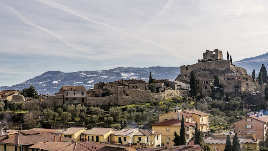The medieval village of Castiglione d'Orcia against the snow-covered hills, Siena, Tuscany, Italy