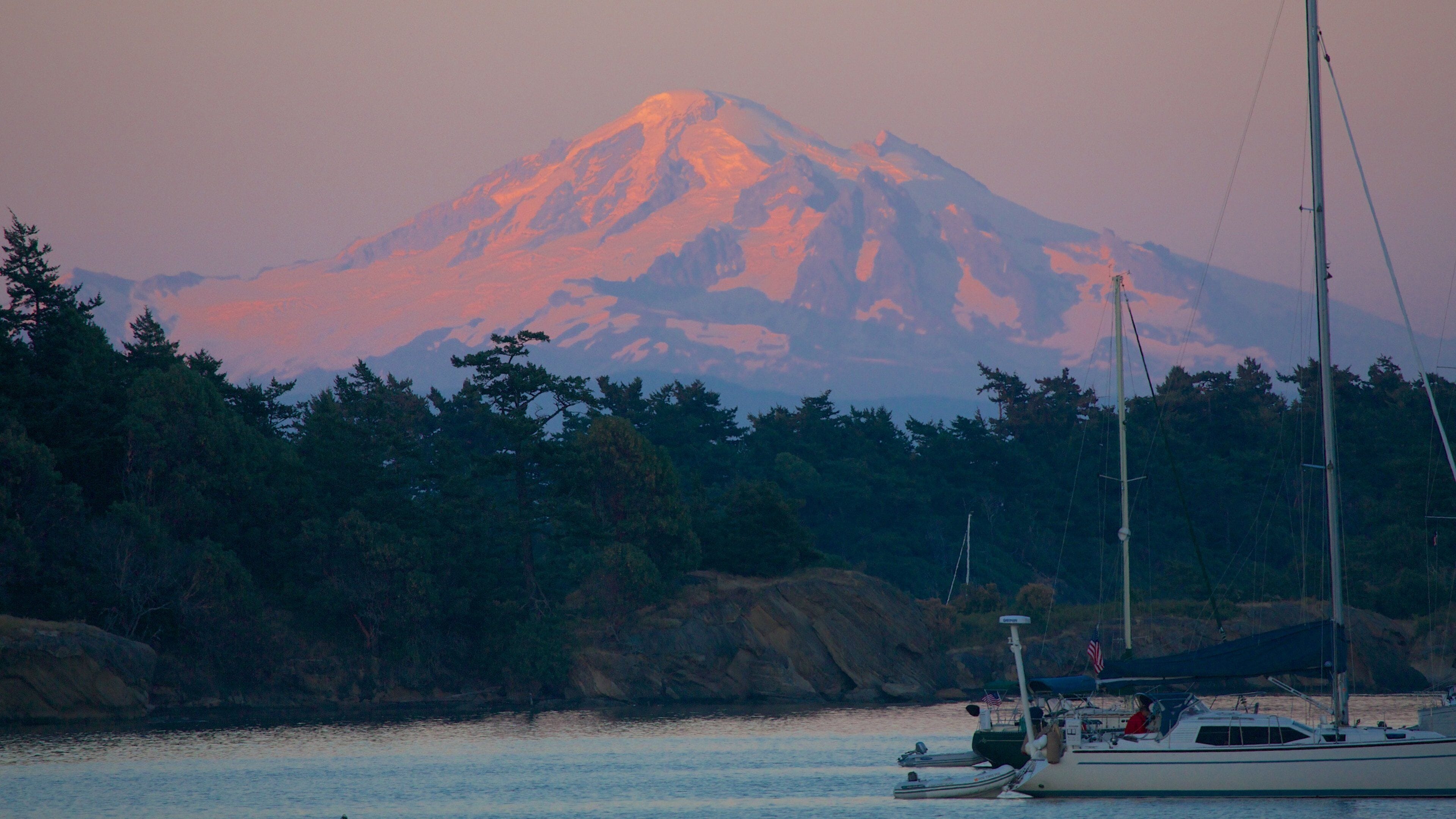 A mountain with a boat in the foreground.