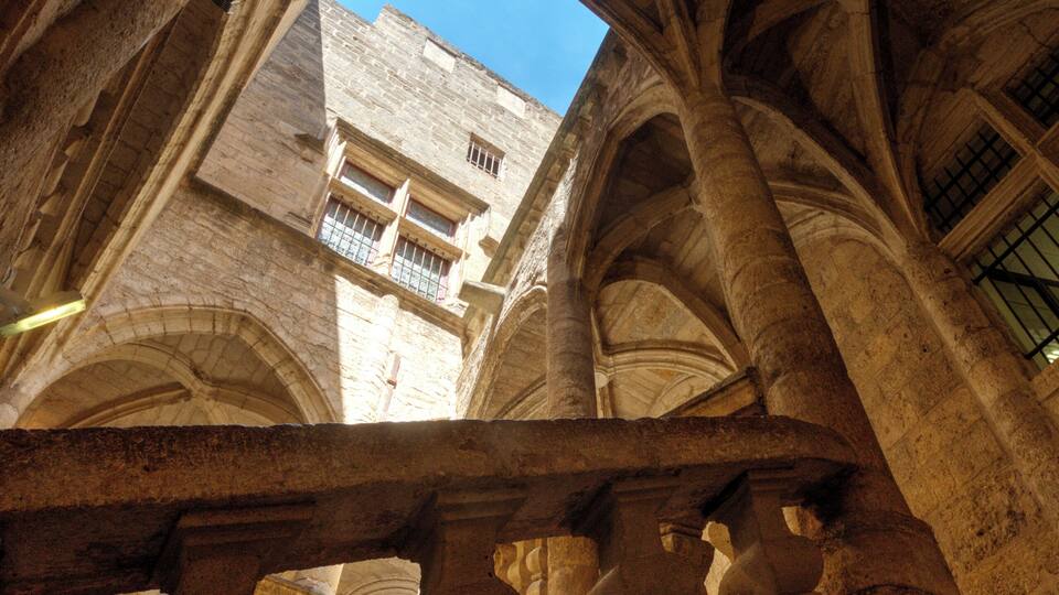An interior view of a cathedral with arched ceilings and stone columns.