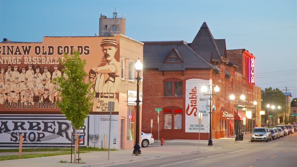 A street with a mural of a baseball team, a barber shop, and a building with a sign for 'Stable'.