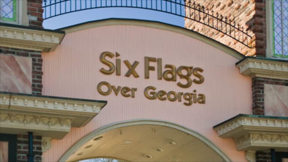 A building with a sign that reads "SixFlags Over Georgia".