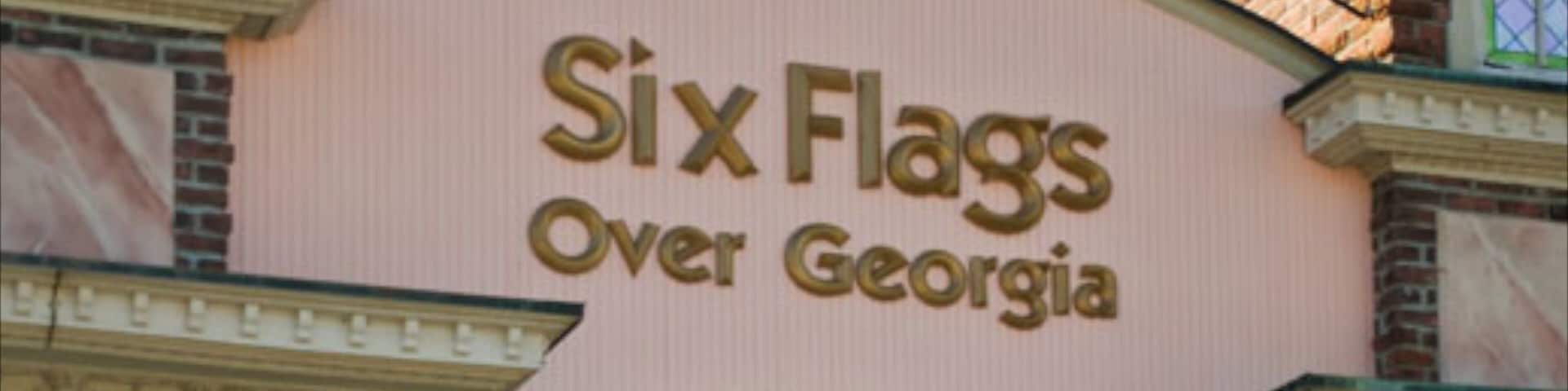 Six Flags Over Georgia which includes signage and rides