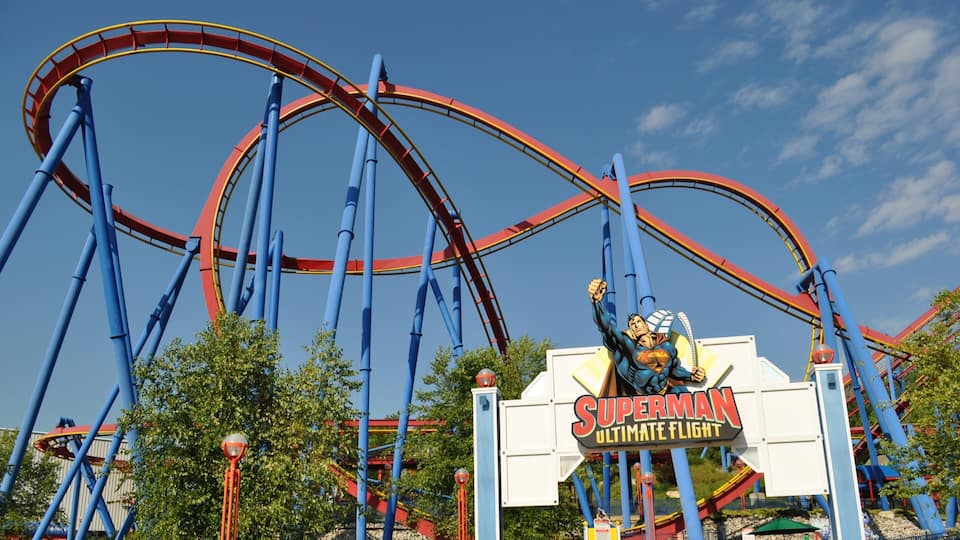 A roller coaster with Superman signage.