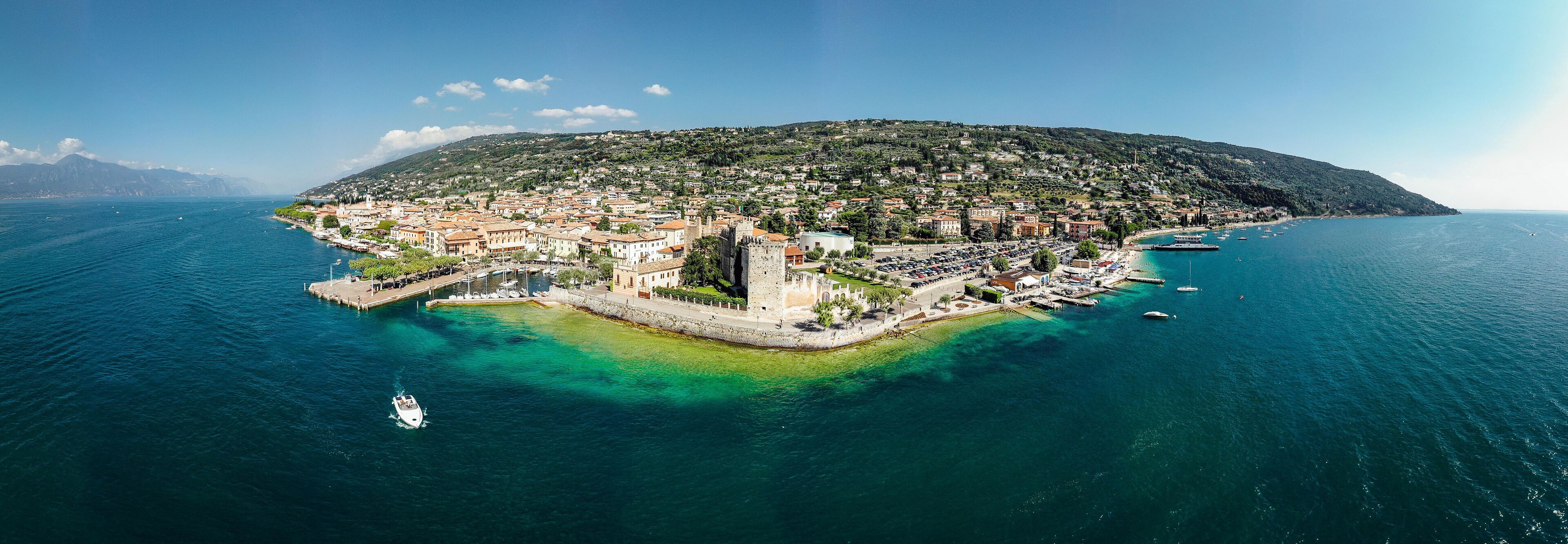Drone shot of Lago di Garda lake in Italy with a view of the Torri del Benaco comune