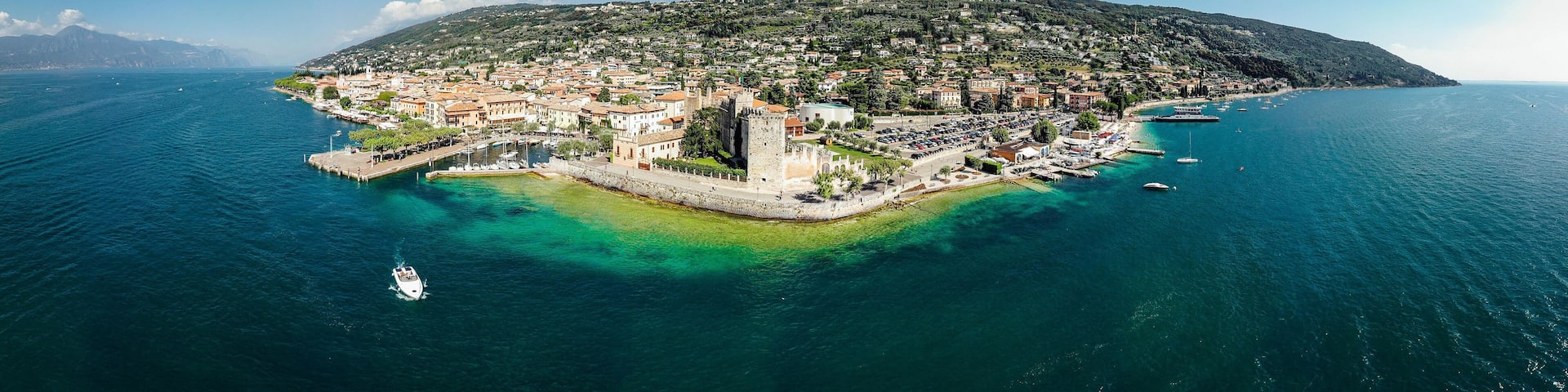 Drone shot of Lago di Garda lake in Italy with a view of the Torri del Benaco comune