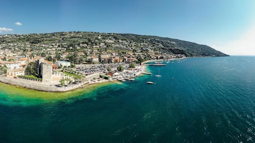 Drone shot of Lago di Garda lake in Italy with a view of the Torri del Benaco comune