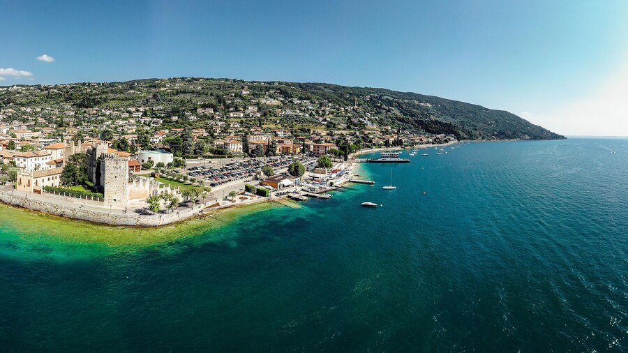 Drone shot of Lago di Garda lake in Italy with a view of the Torri del Benaco comune