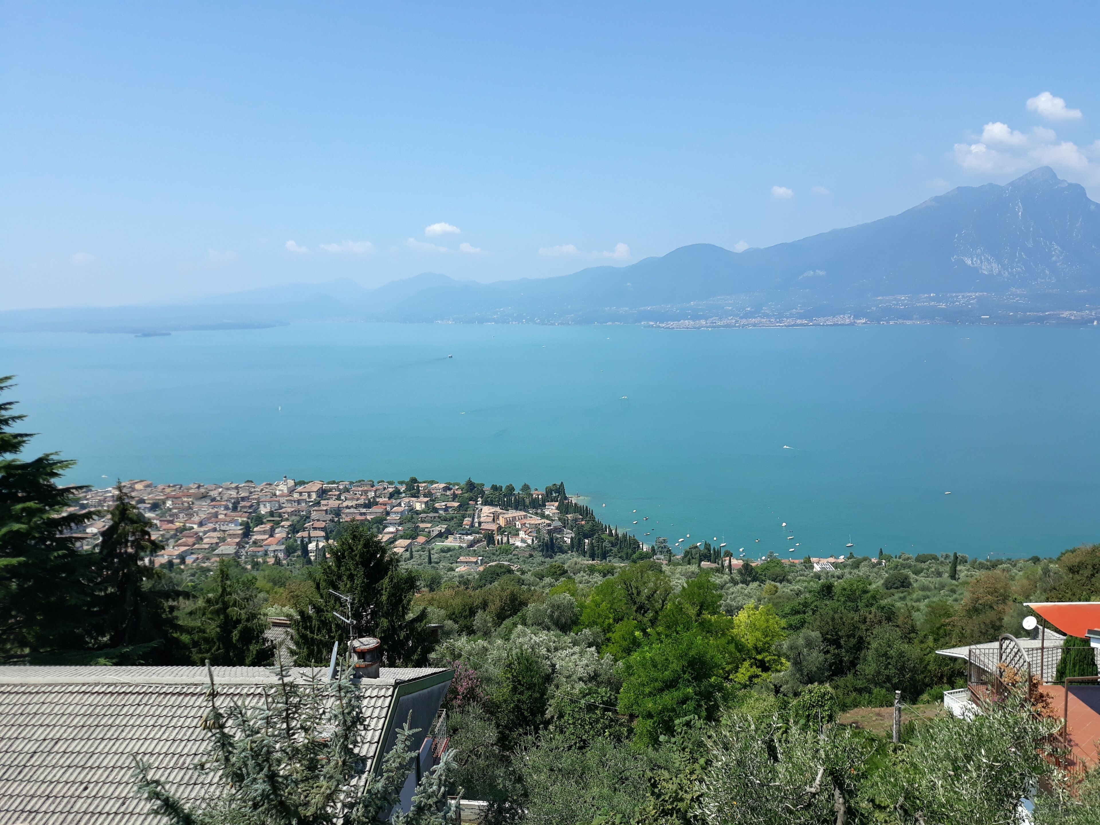 A coastal town with a view of the sea and mountains in the background.