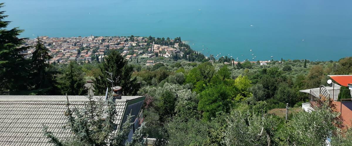 A coastal town with a view of the sea and mountains in the background.
