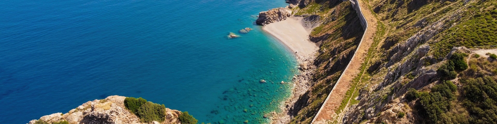 Aerial drone. Capo Calava bay and beach, with several holiday parks, resort and villages, near Gioiosa Marea, Sicily, Italy.