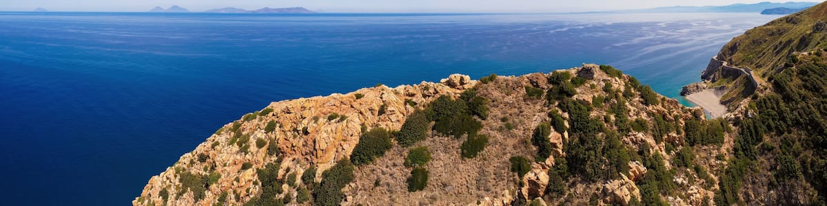 Aerial drone. Capo Calava bay and beach, with several holiday parks, resort and villages, near Gioiosa Marea, Sicily, Italy.
