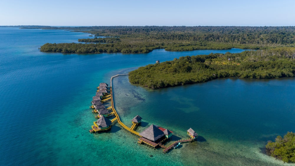 Aerial shot of luxury hotel and water bungalow in the Caribbean sea, Bocas del Toro island, Panama - stock photo