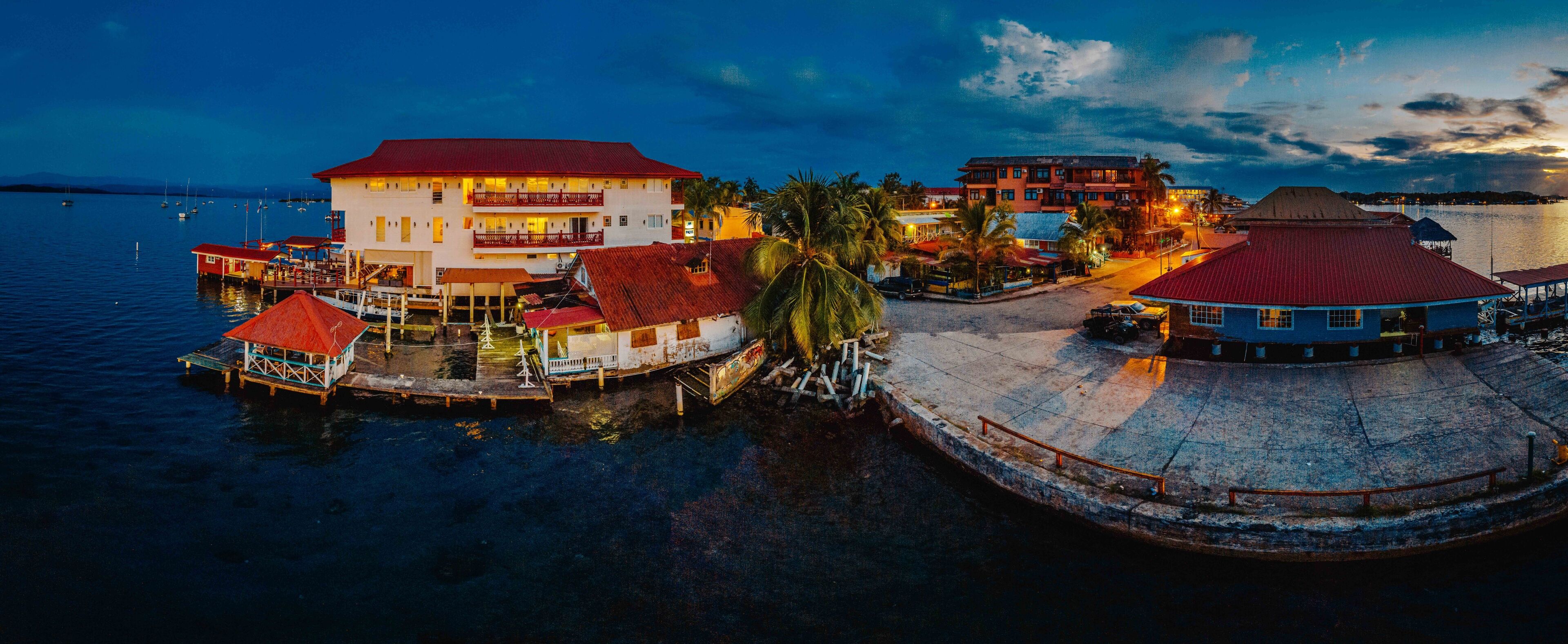 A waterfront area with buildings, boats, and a dock.