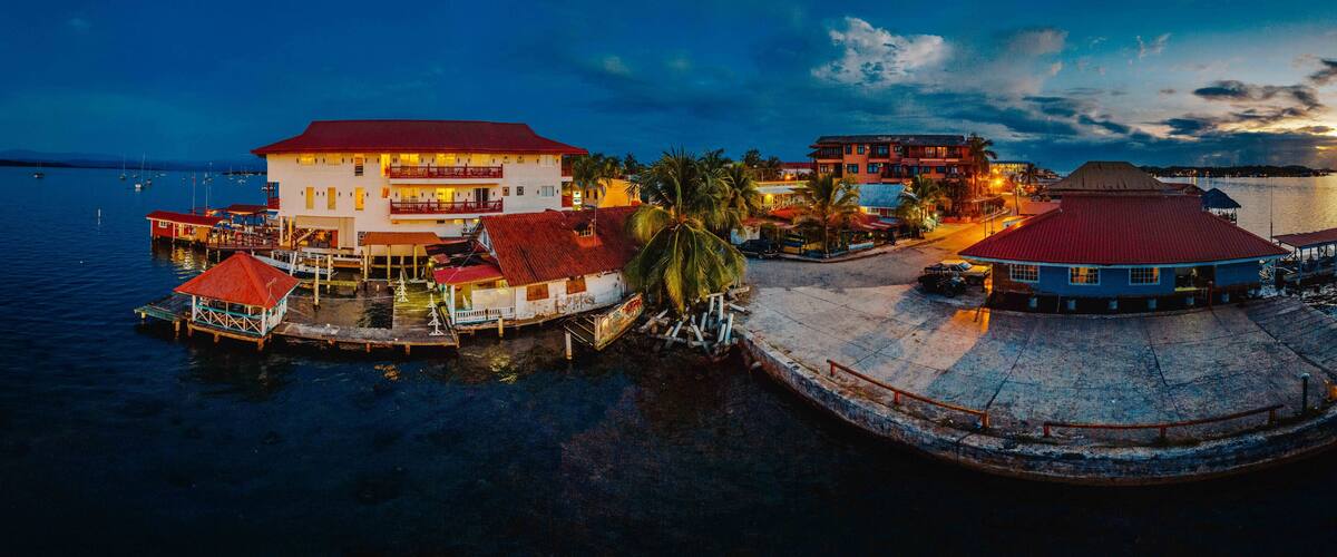 A waterfront area with buildings, boats, and a dock.