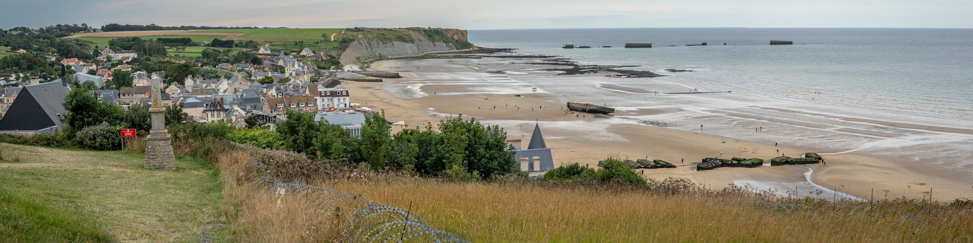 Arromanches-les-Bains, France - 08 08 2025: Normandy landing blockhouse. Panoramic view of the artificial port, the beach, the sea, cliffs and the city