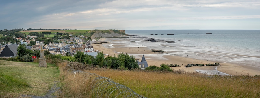 Arromanches-les-Bains, France - 08 08 2025: Normandy landing blockhouse. Panoramic view of the artificial port, the beach, the sea, cliffs and the city