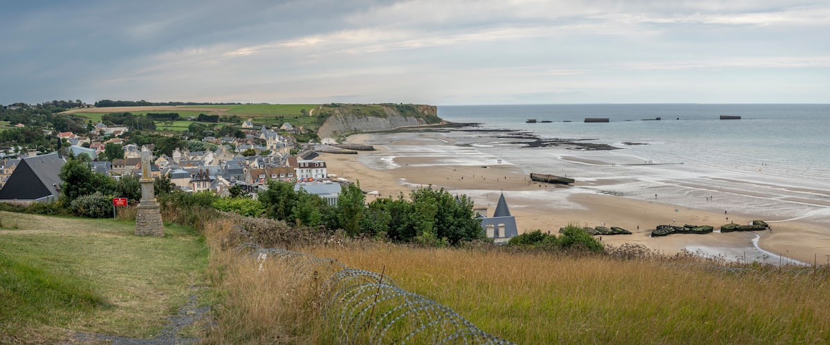 Arromanches-les-Bains, France - 08 08 2025: Normandy landing blockhouse. Panoramic view of the artificial port, the beach, the sea, cliffs and the city