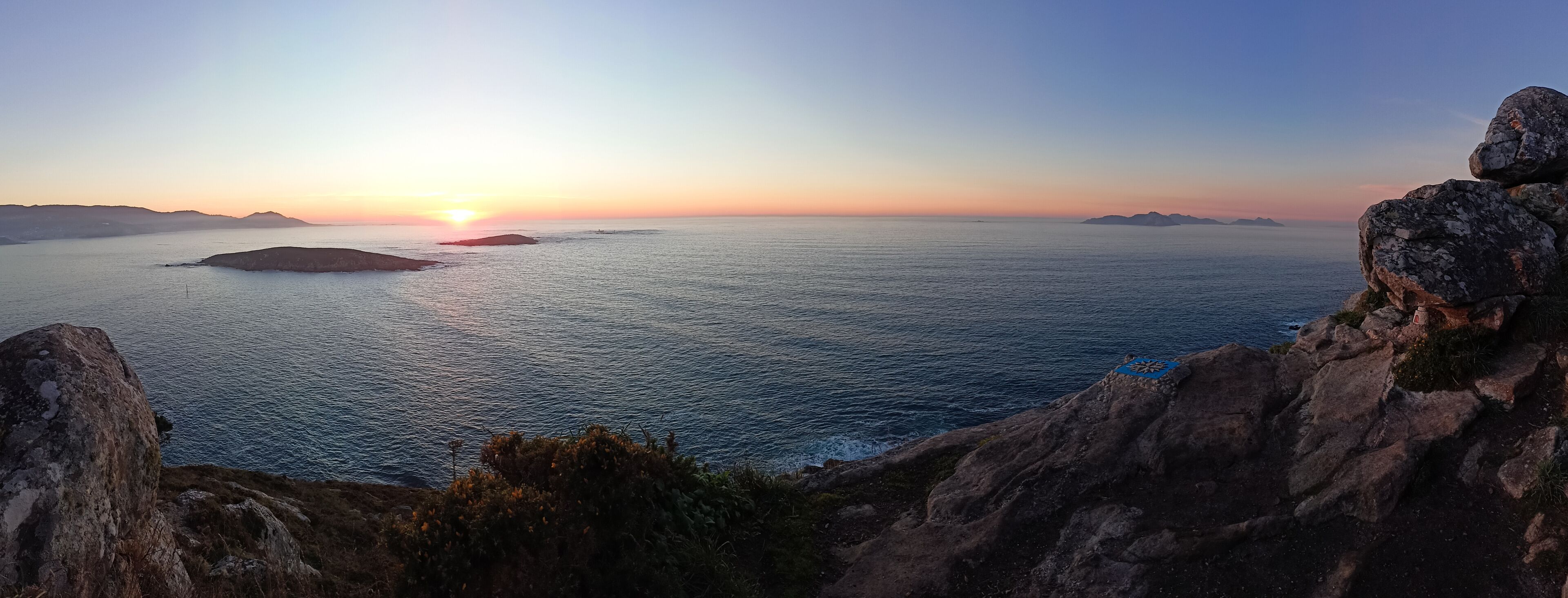 Panoramic view from the compass rose viewpoint in Monteferro of the Cies Islands, the Estelas Islands and Baiona at sunset. Nigran - Spain