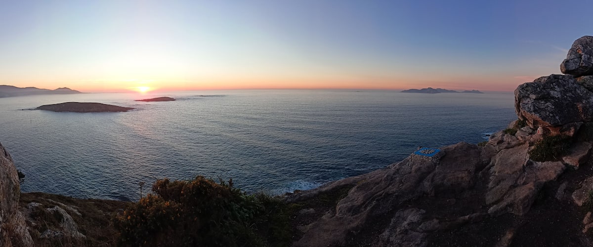 Panoramic view from the compass rose viewpoint in Monteferro of the Cies Islands, the Estelas Islands and Baiona at sunset. Nigran - Spain