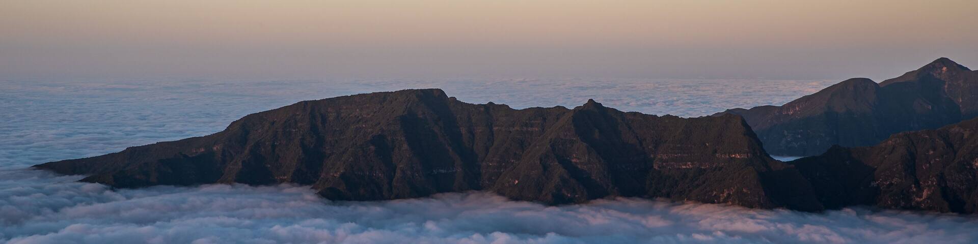 Rocky mountain ridge above clouds - view from Bica da Cana viewpoint in Madeira