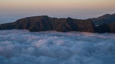Rocky mountain ridge above clouds - view from Bica da Cana viewpoint in Madeira
