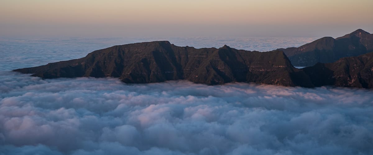 Rocky mountain ridge above clouds - view from Bica da Cana viewpoint in Madeira