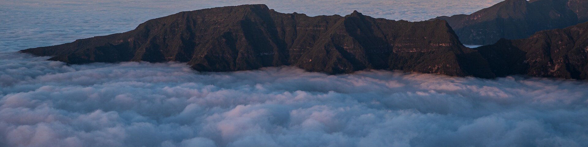 Rocky mountain ridge above clouds - view from Bica da Cana viewpoint in Madeira