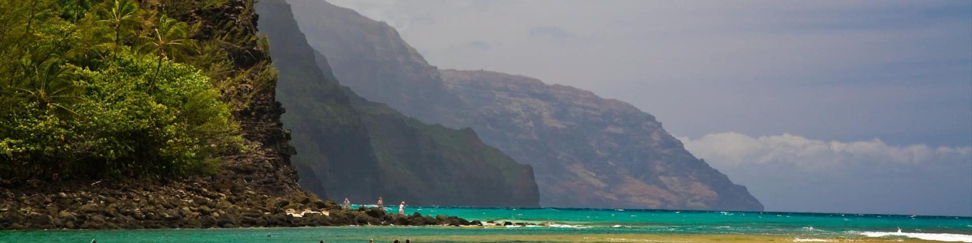 Haena showing mist or fog, a sandy beach and rocky coastline
