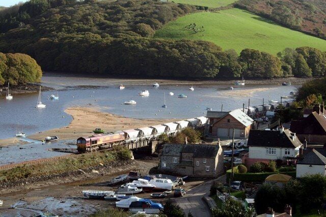 Clay empties cross Golant harbour, near to Golant, Cornwall, Great Britain.