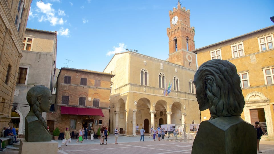A historic square with a prominent tower and statues.
