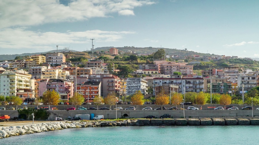 Tall buildings on the side of the road going to the port in Italy