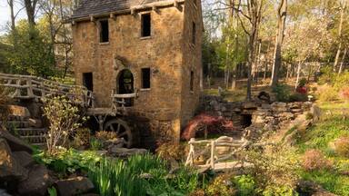 Historical place of Old Mil in Little Rock in Arkansas with flowers and plants near waterfall