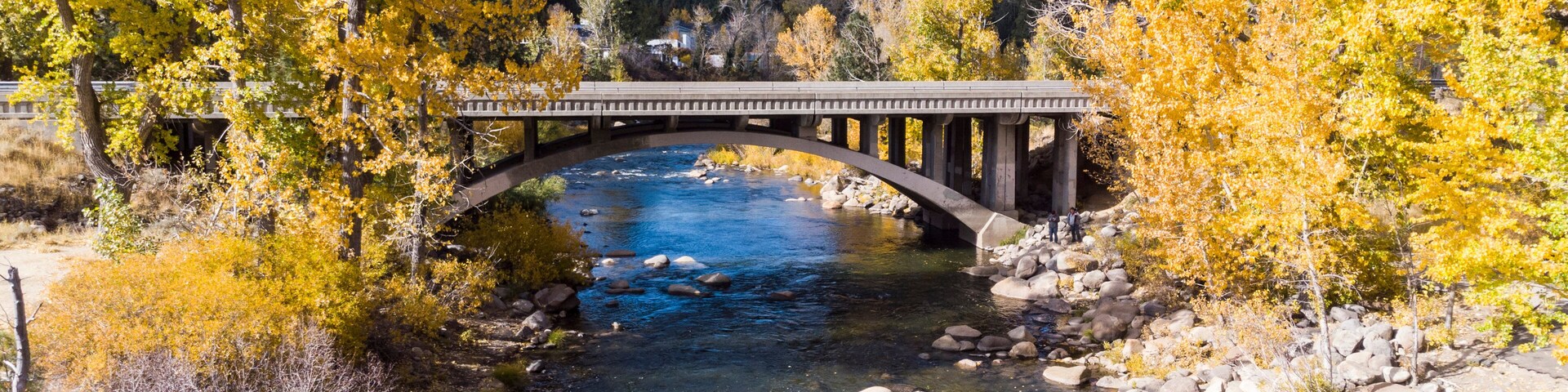Drone point of view over the Truckee river as it passes under a bridge near Crystal Peak park in Verdi