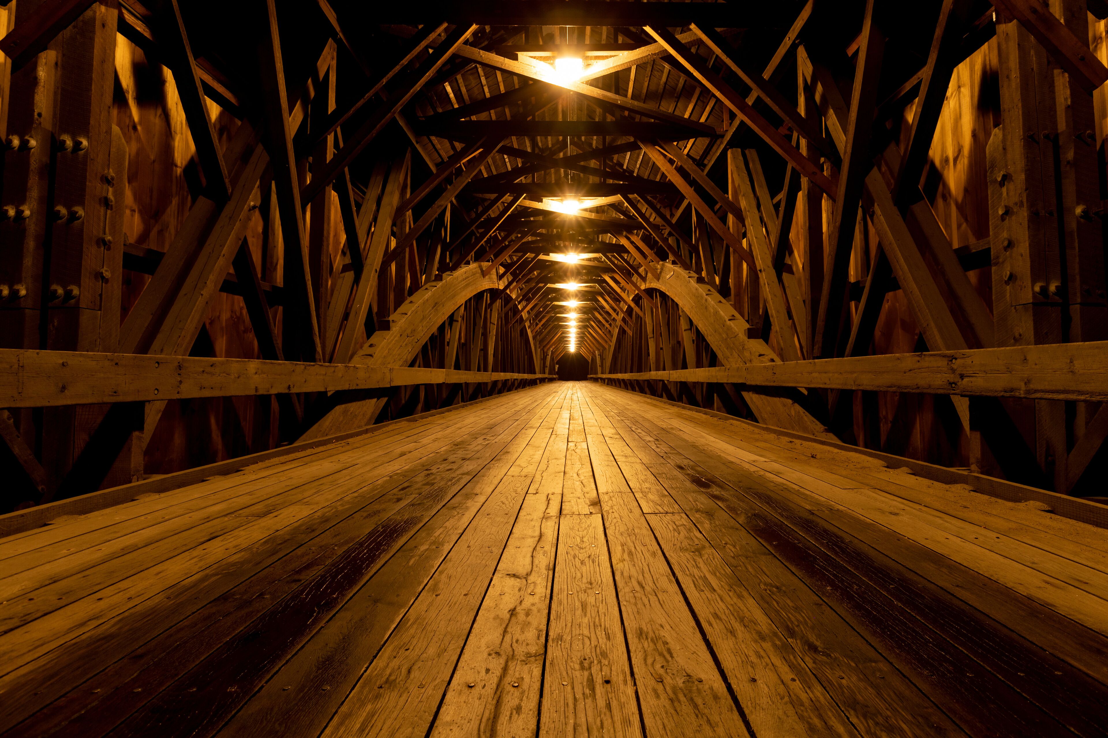 Modern lights brighten the wooden structure of the Blair Covered Bridge in Campton, New Hampshire