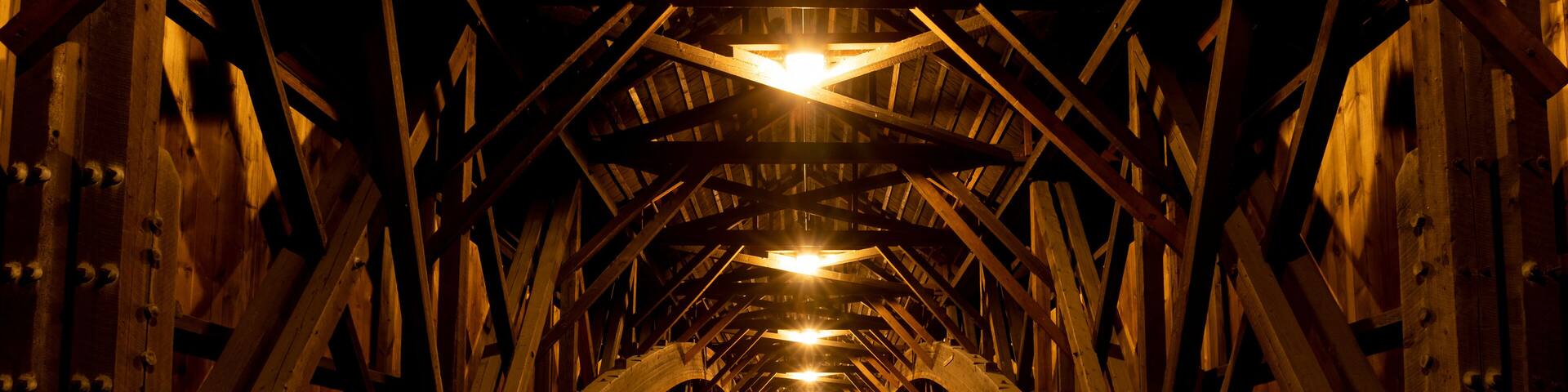 Modern lights brighten the wooden structure of the Blair Covered Bridge in Campton, New Hampshire