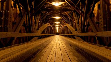 Modern lights brighten the wooden structure of the Blair Covered Bridge in Campton, New Hampshire