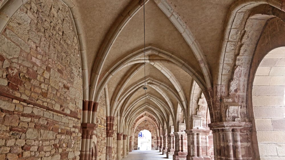 A long corridor with arched ceilings and stone walls.