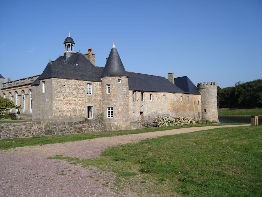 A large stone castle with multiple towers and a moat.