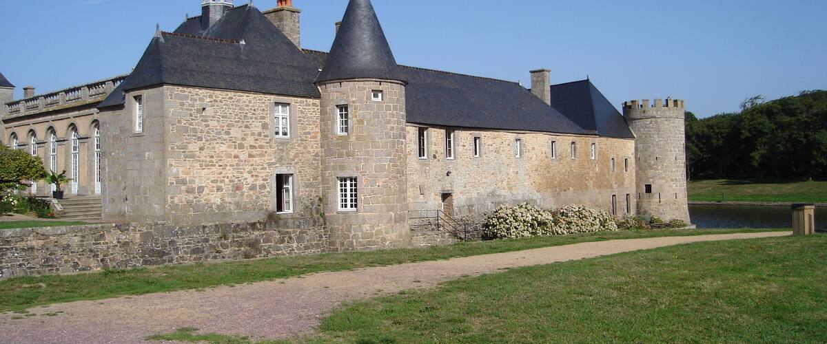 A large stone castle with multiple towers and a moat.