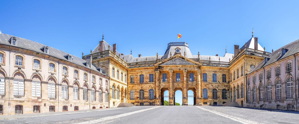 A grand historic building with a central dome and arched windows.