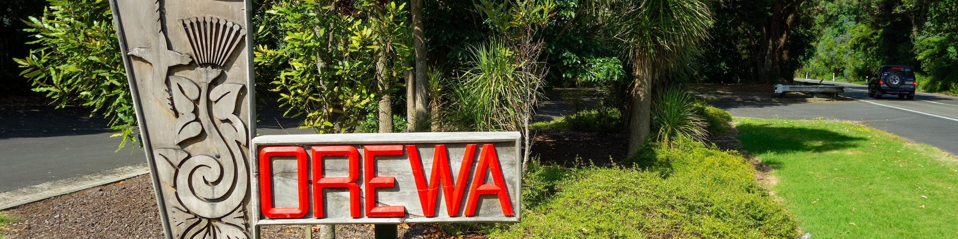 Orewa which includes signage and a garden