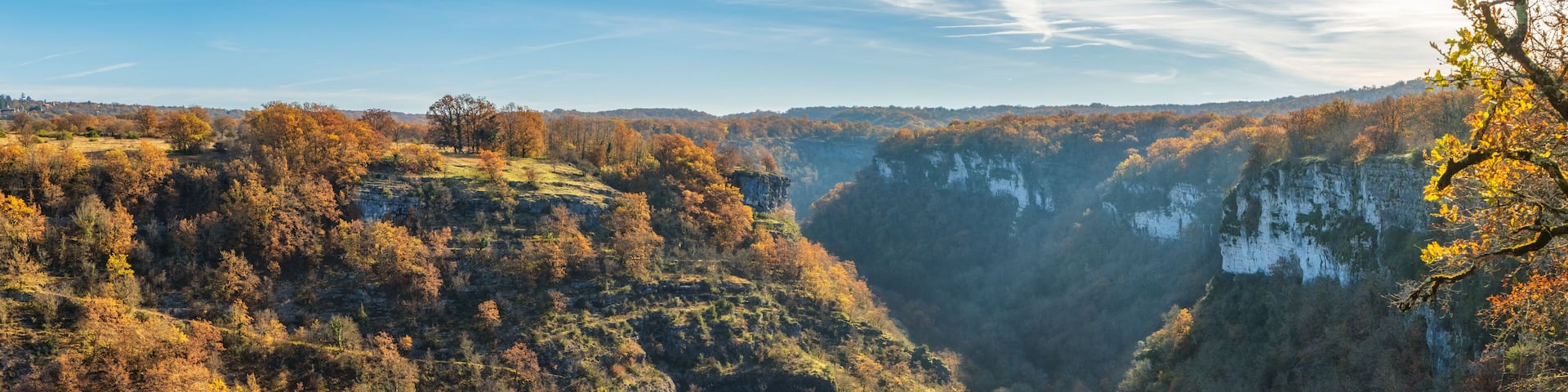 Steep sided tree lined canyon plunging down to the Alzou river near Gramat in the Lot region of France