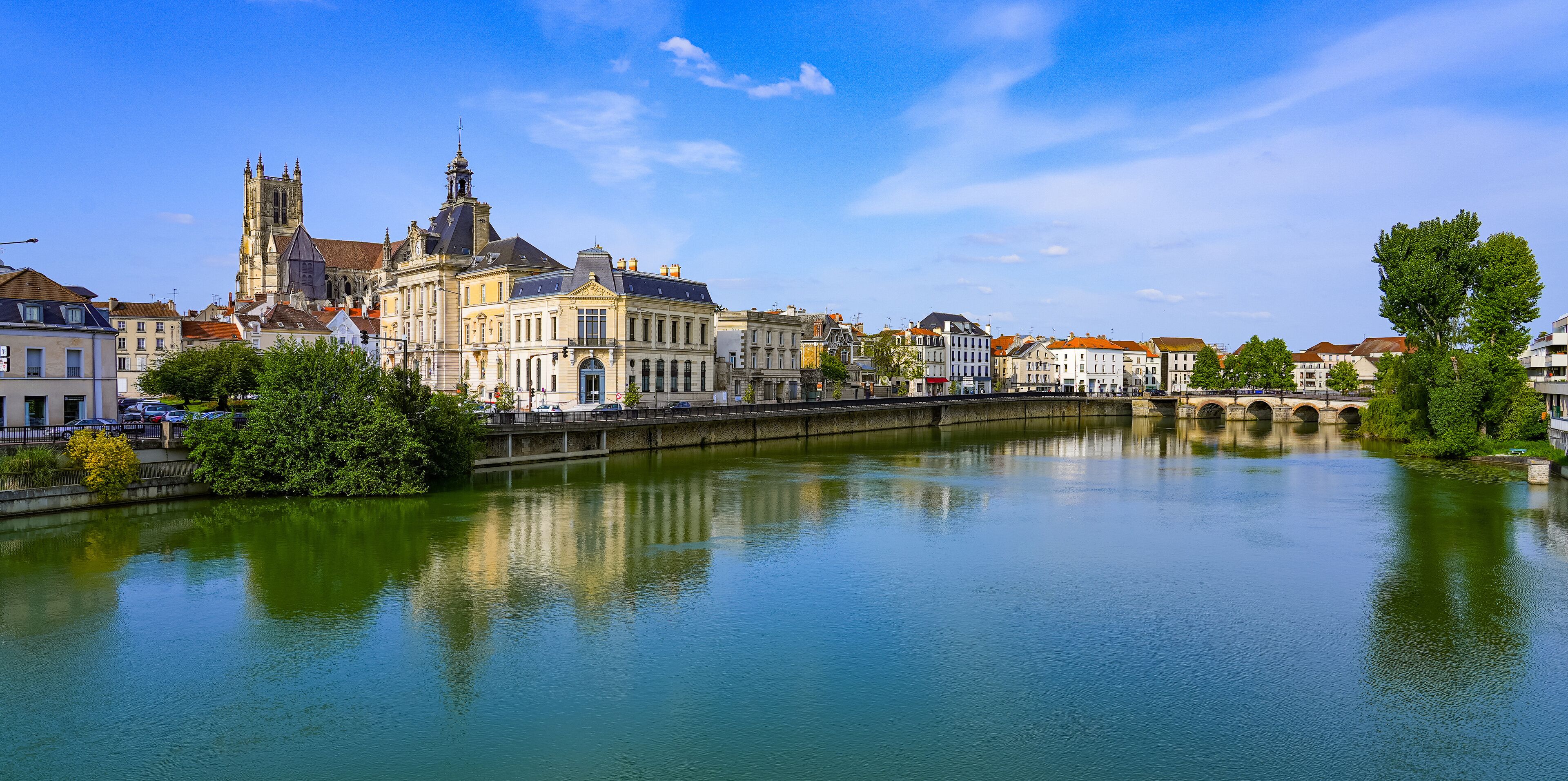 Reflection of Saint Stephen's cathedral overlooking the City Hall of Meaux in the Marne river in the Seine et Marne Department near Paris, France