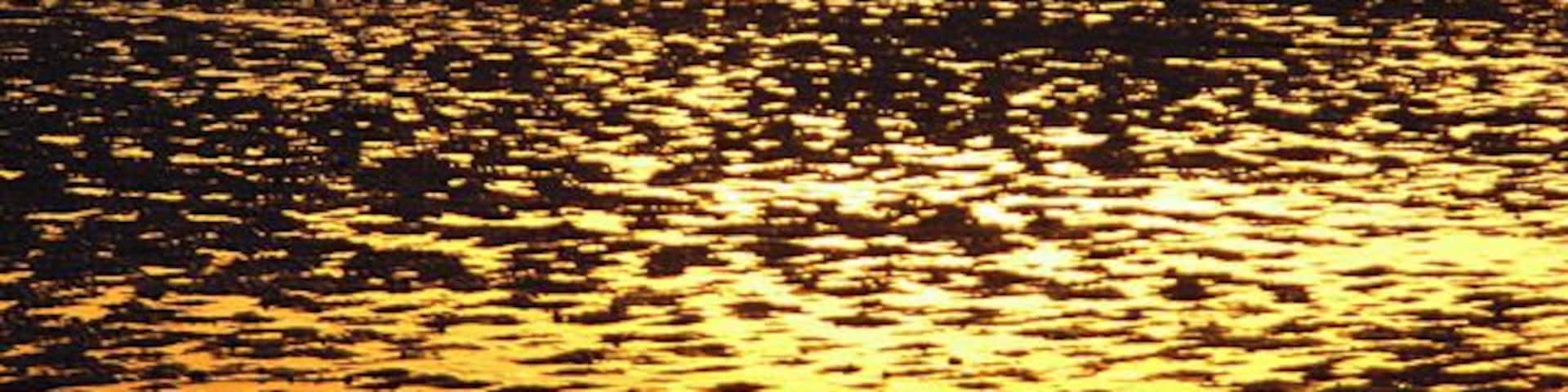 Solway sunset Wet sand at low tide with Kirkcudbrightshire just visible.