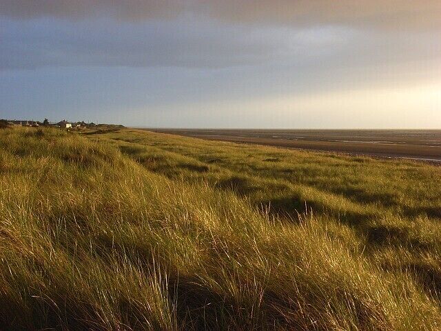 Wolsty Bank These grassy dunes are a nature reserve. A few houses in Beckfoot are visible beyond.