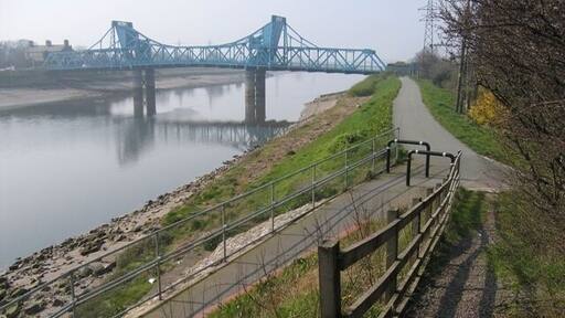 Queensferry Bridge The old Queensferry bridge viewed from the footpath by the modern bridge. The tarmac path below is the cycleway that runs along the bank of the River Dee all the way from Chester.