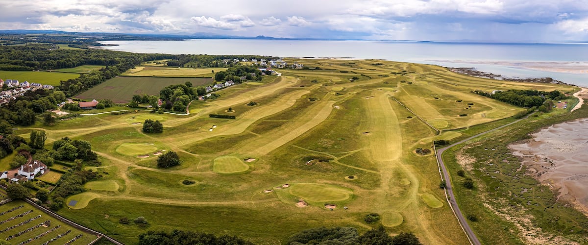 A golf course with a coastal view.