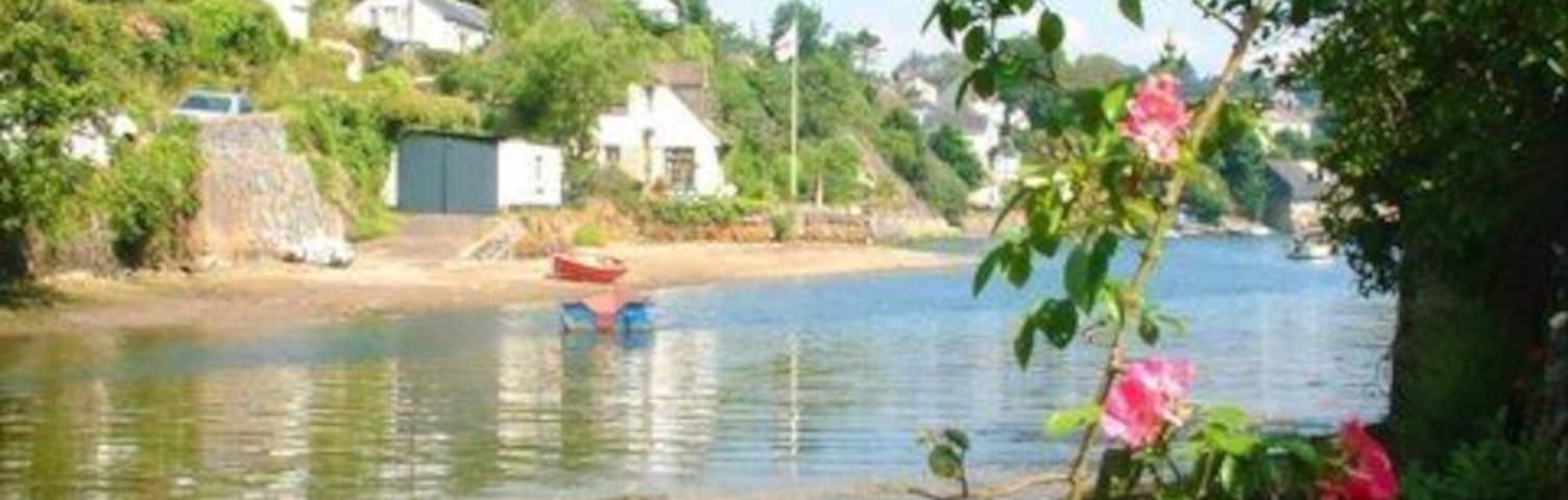 A summer morning in Helford Whitewashed cottages slope gently down to the Helford River on a summer morning in May 2005.