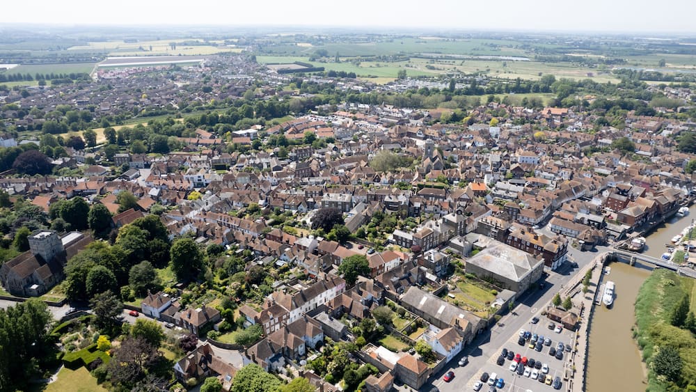 An aerial view of a densely populated town with a river running through it.